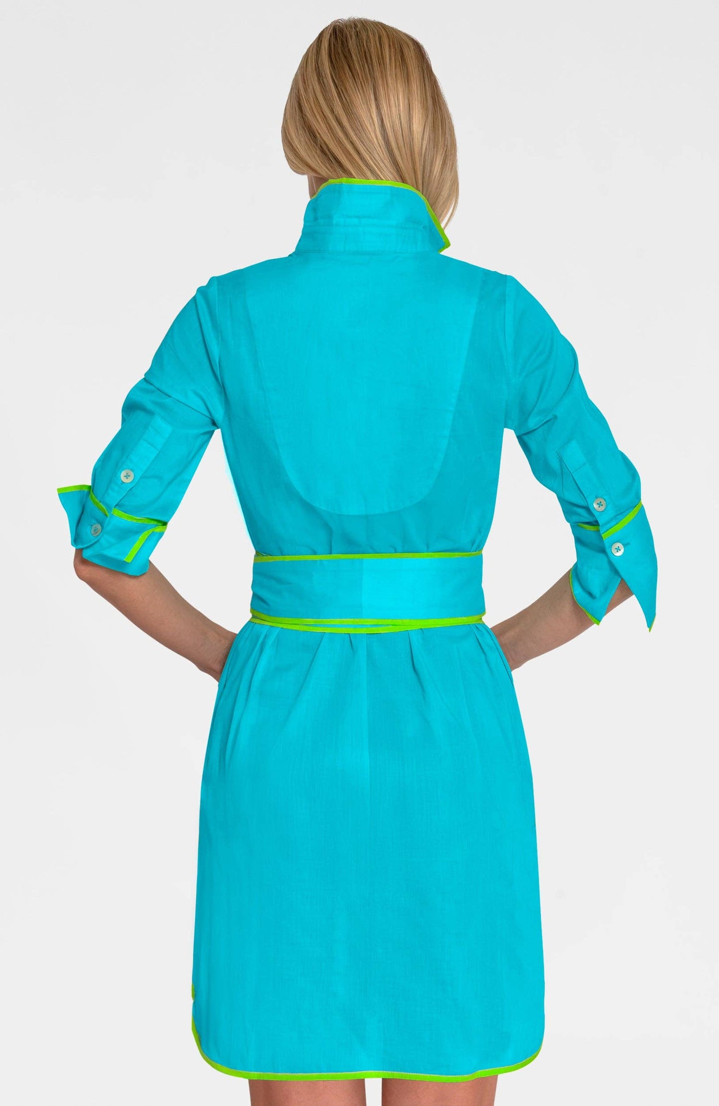 Turquoise dress with green accents worn by a person on a white background