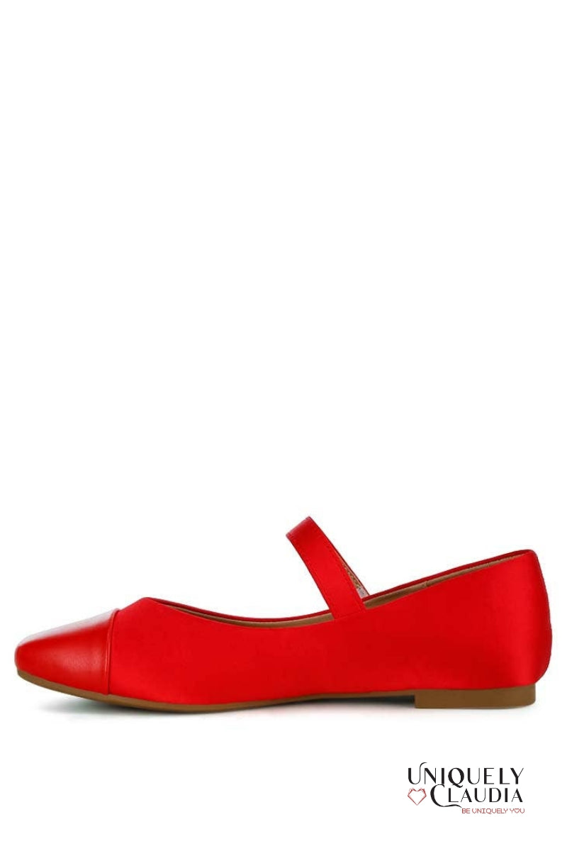 Red shoe with a brown sole on a white background