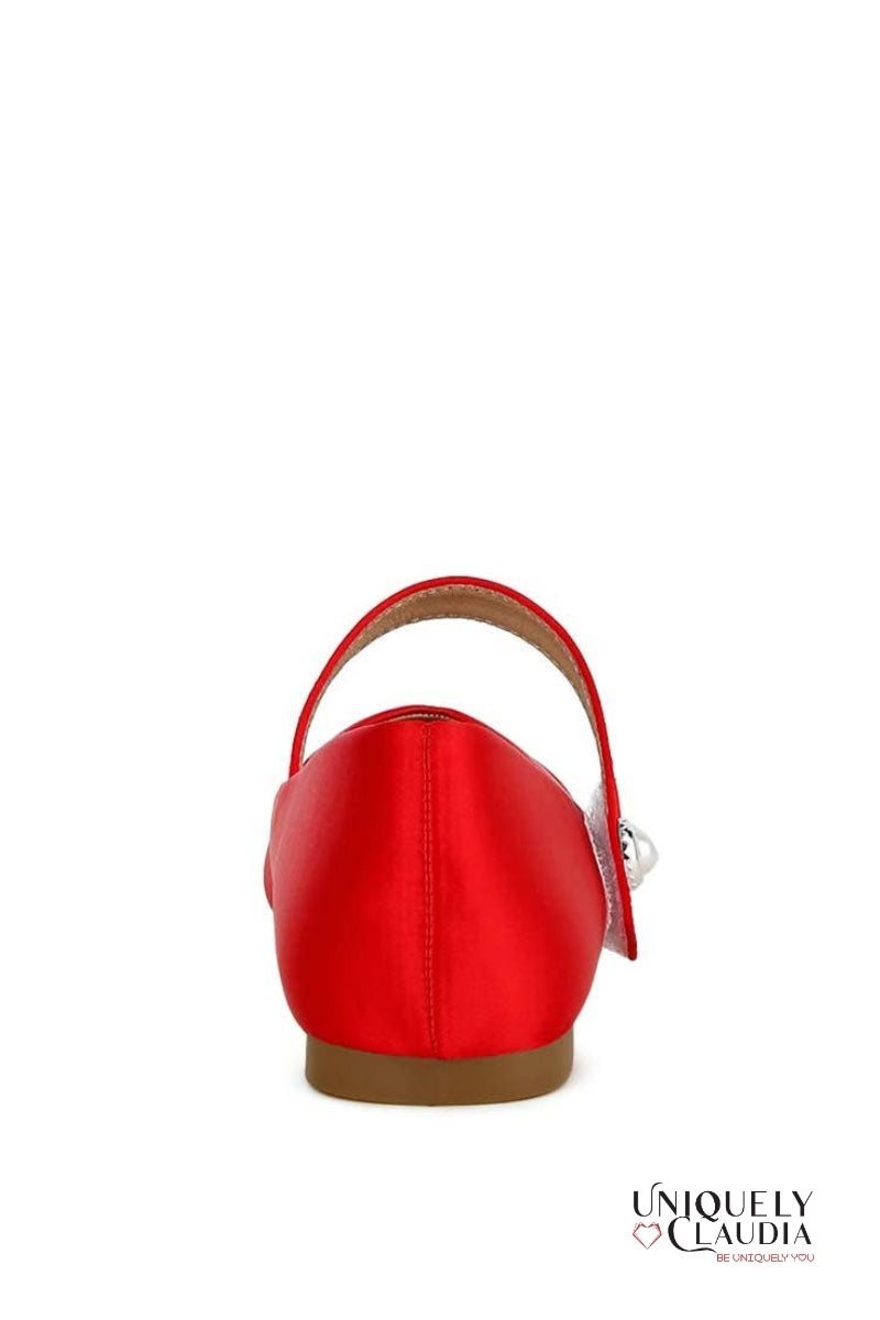 Red shoe with a brown sole on a white background