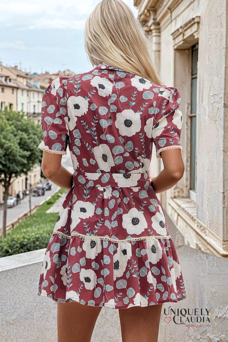 Woman wearing a floral dress with a blurred street scene in the background