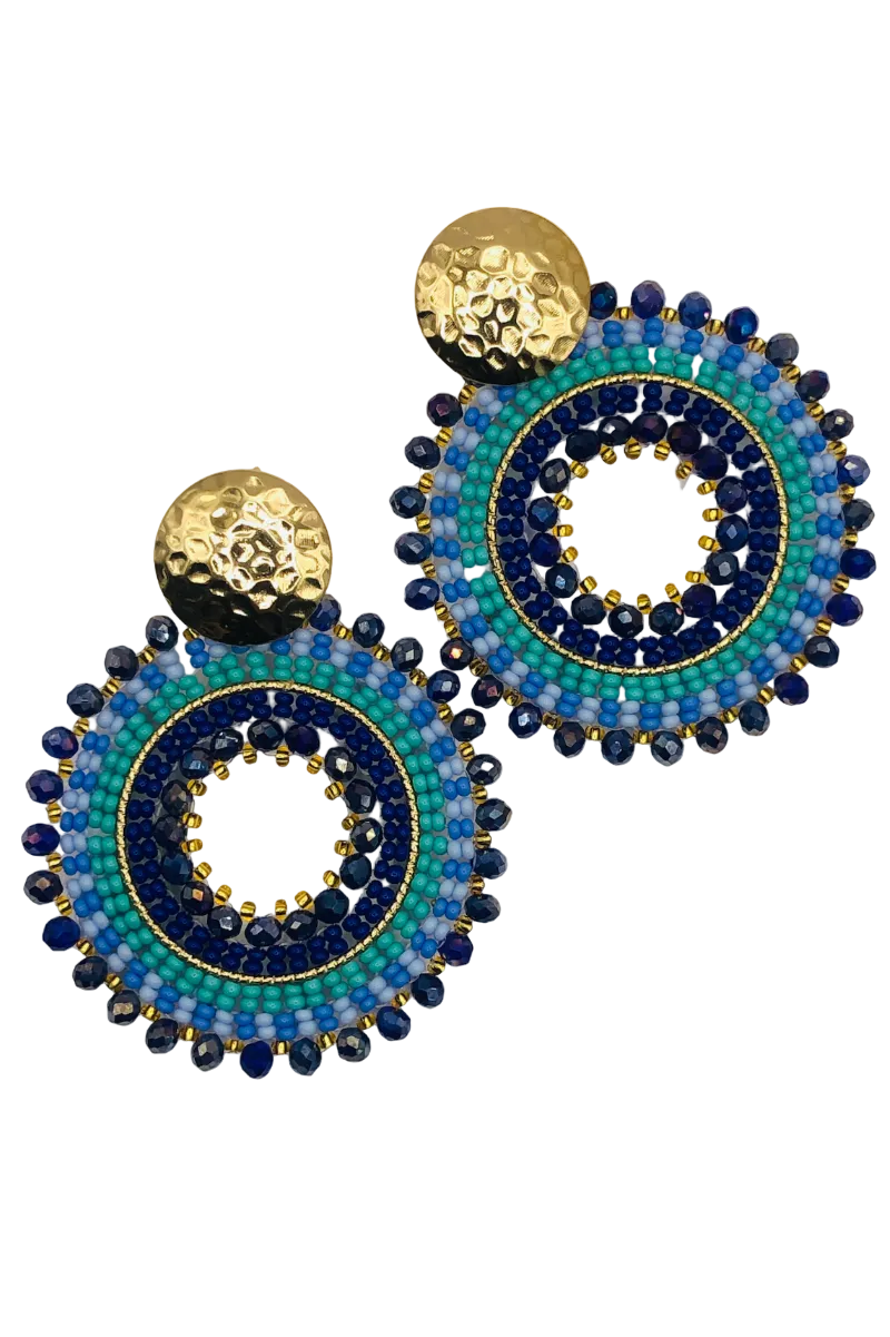 Pair of beaded earrings with blue and gold design on a white background