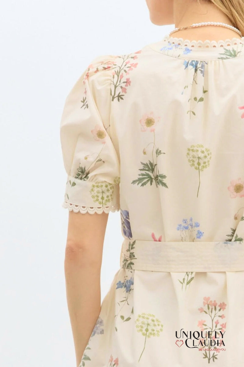 Floral-patterned dress with 'Uniquely Claudia' branding on a light background