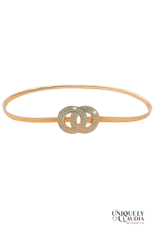 Gold belt with interlocking circular design on a white background