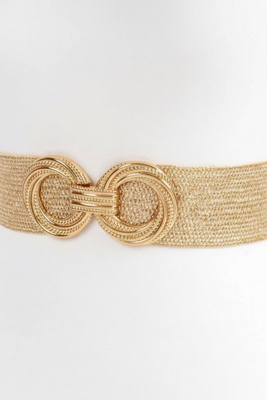 Gold woven belt with a large circular buckle on a white background