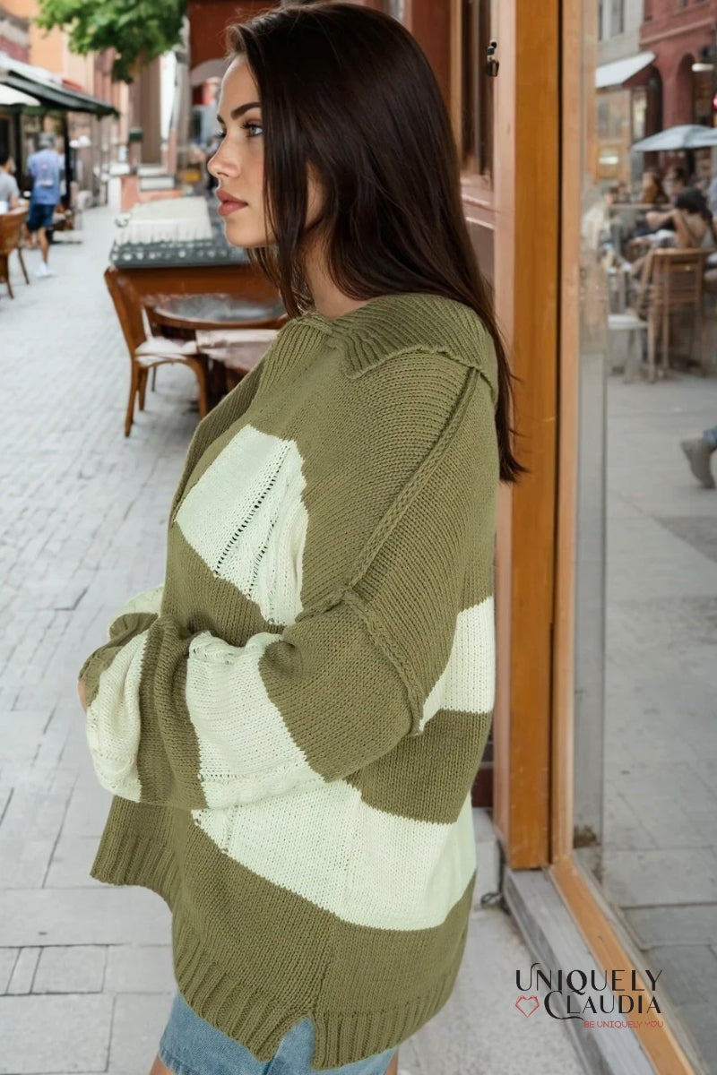 Woman wearing a green and white patterned sweater on a city street.