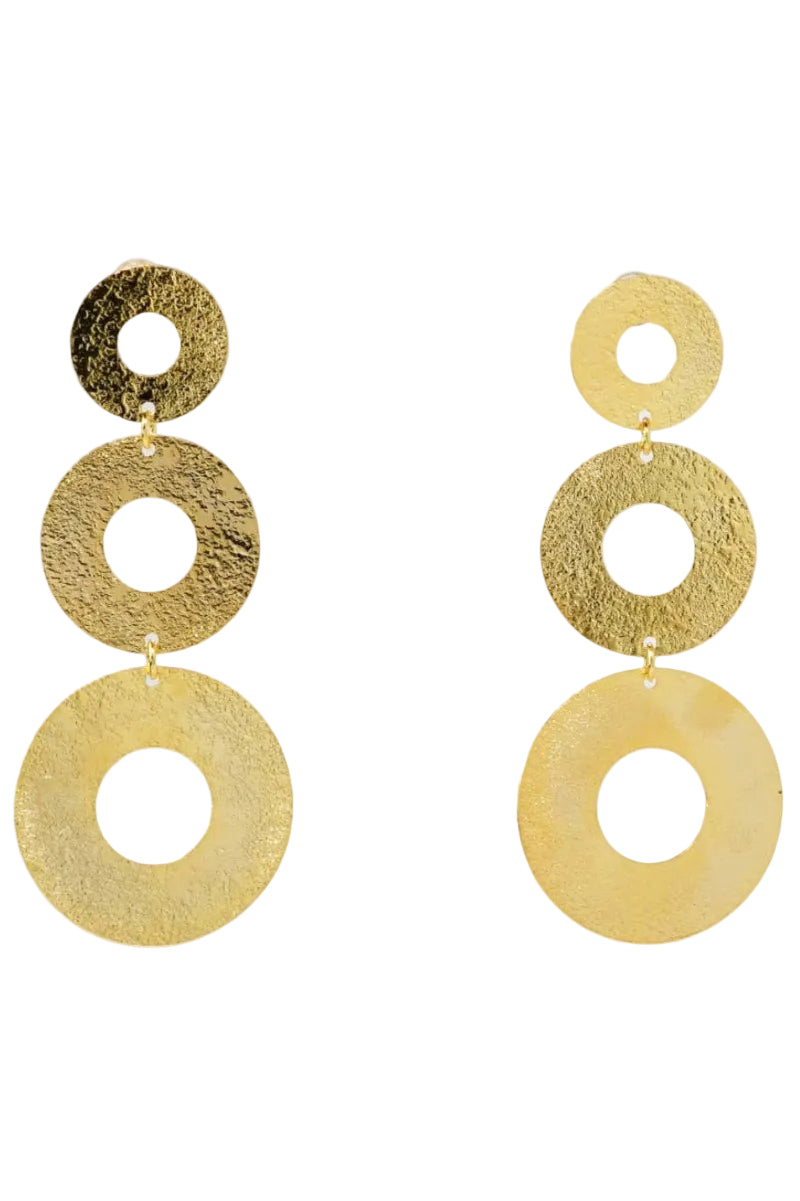 Gold circular earrings on a light gray background