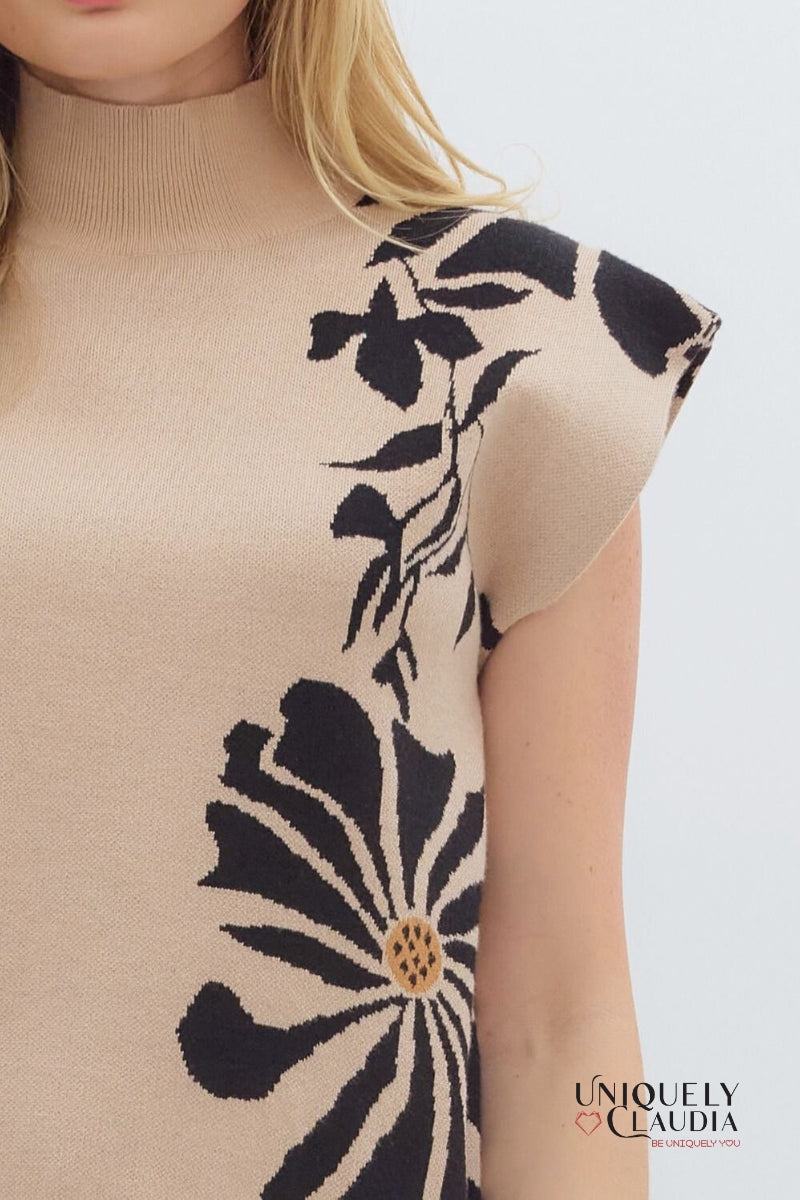 Beige sleeveless top with black floral pattern on a white background