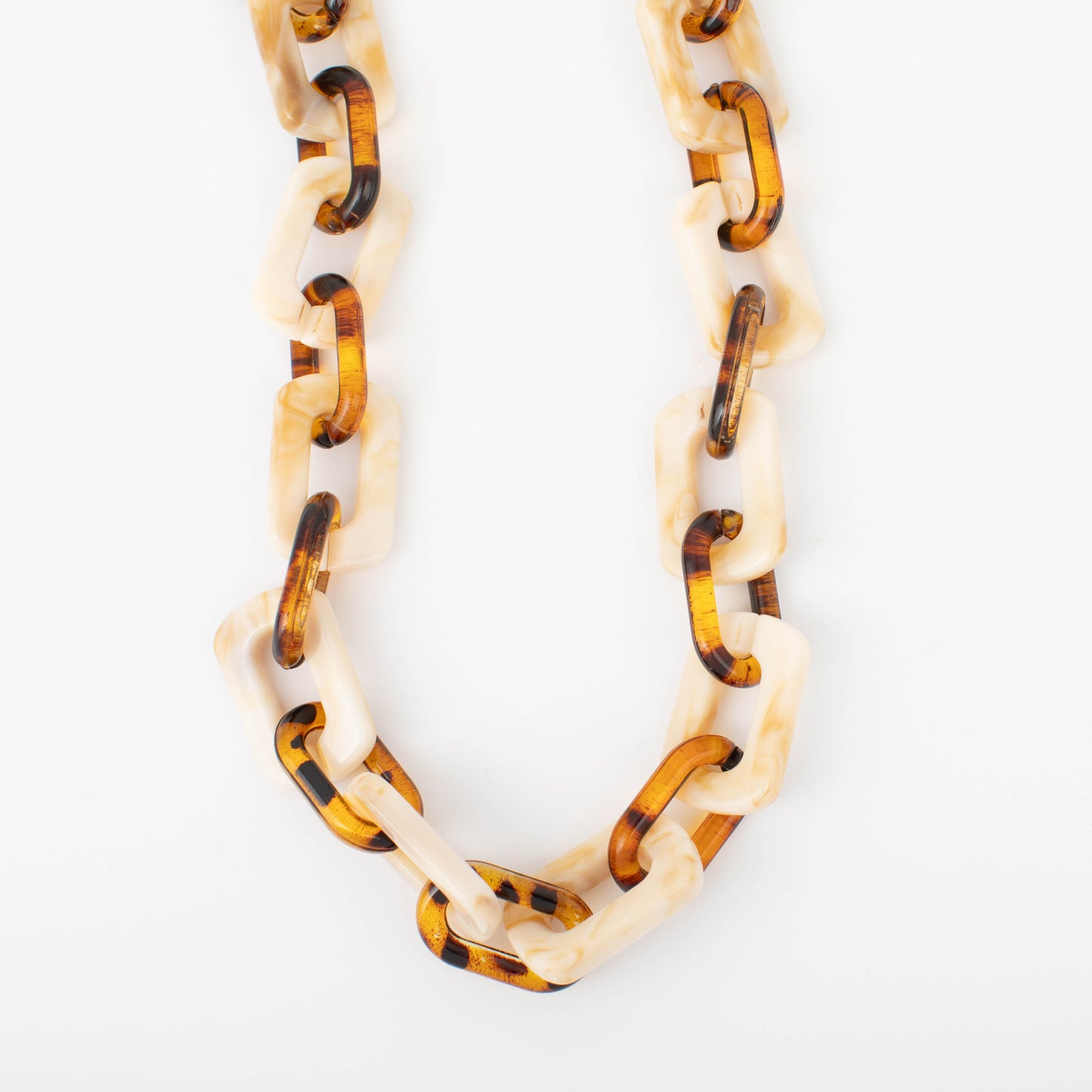 Necklace with tortoiseshell and cream-colored links on a white background