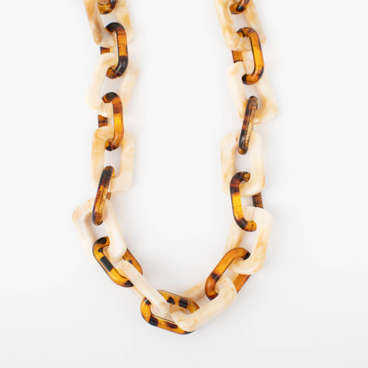 Necklace with tortoiseshell and cream-colored links on a white background