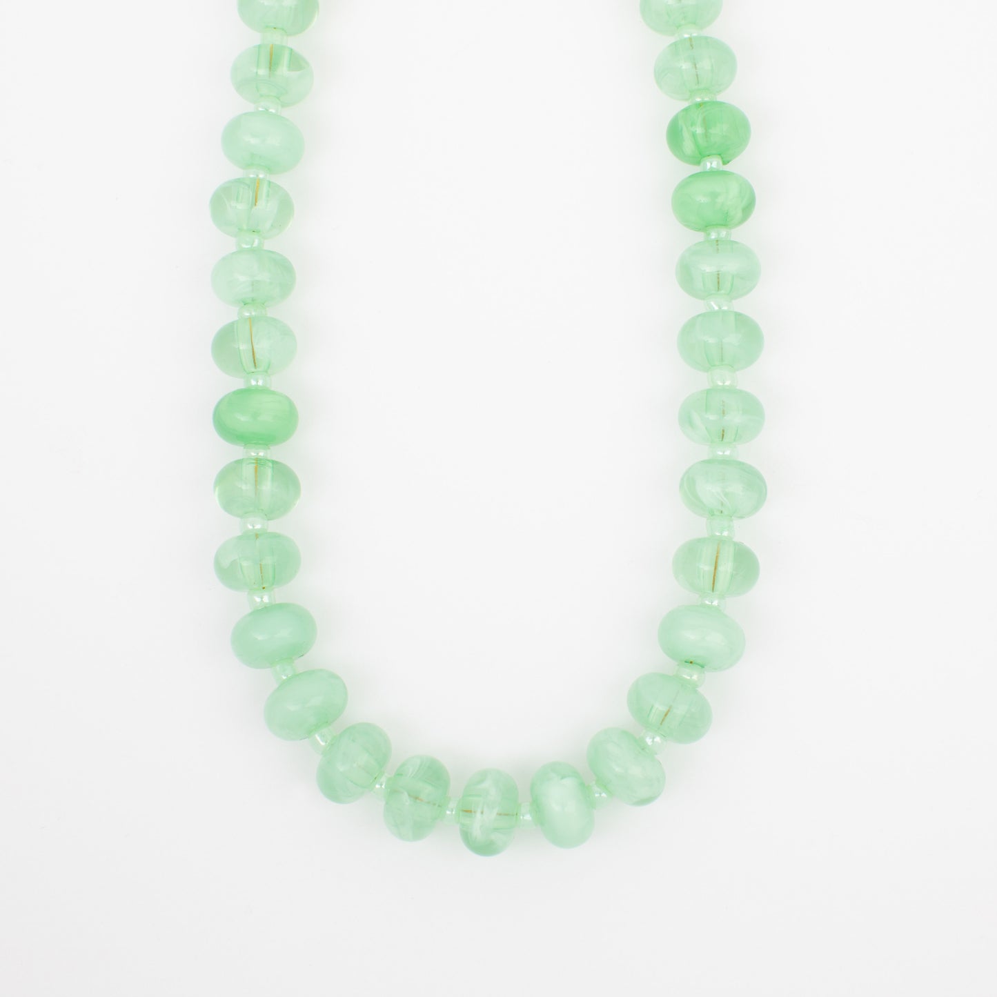 Green beaded necklace on a white background