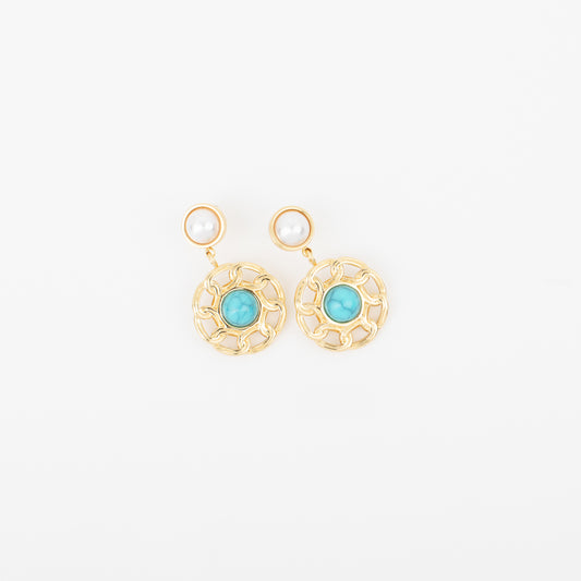 Gold earrings with turquoise stones on a white background