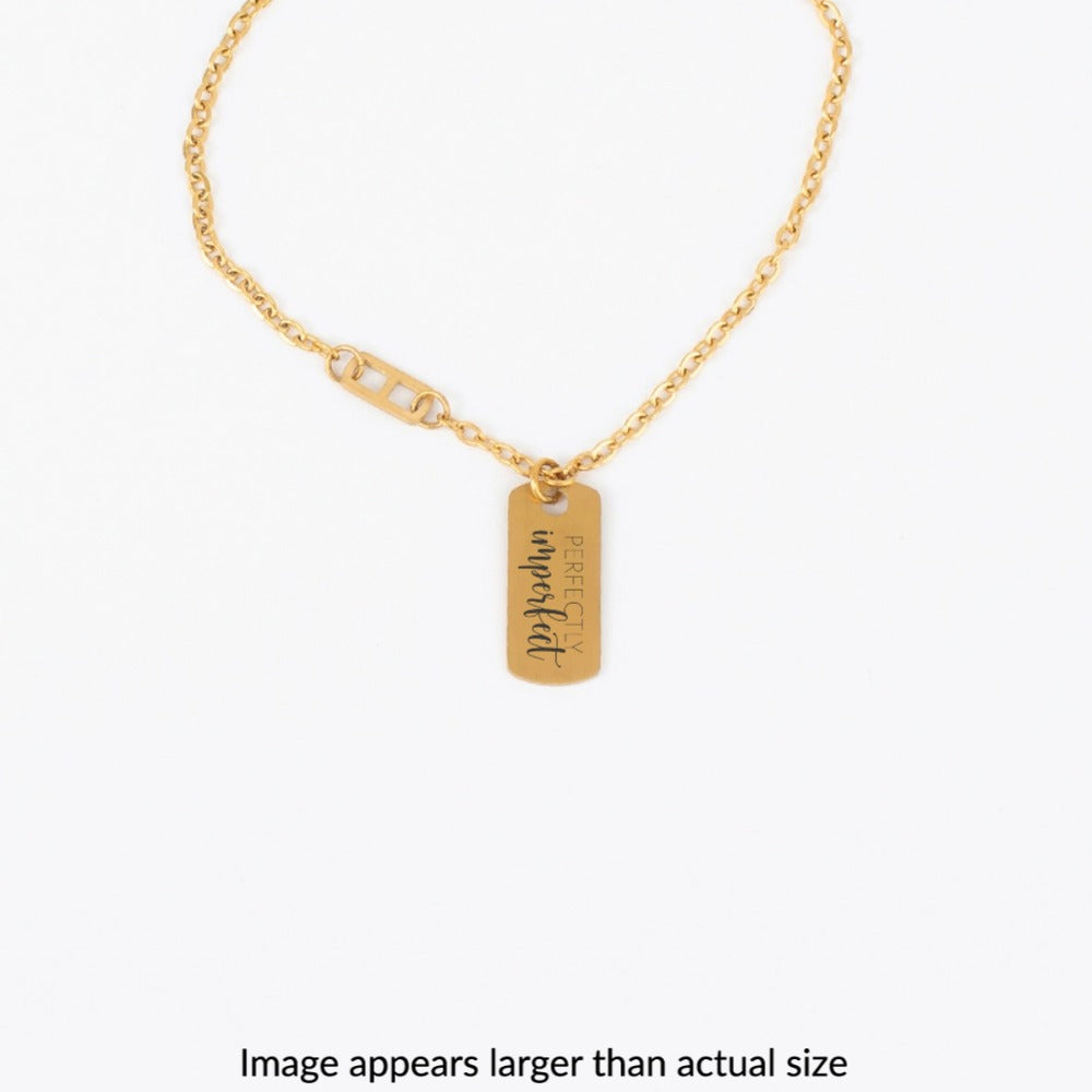 Gold necklace with a tag on a white background