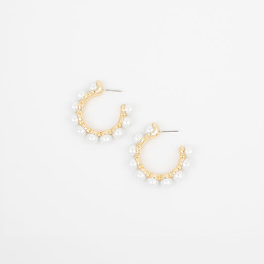 Gold hoop earrings with pearl-like beads on a white background
