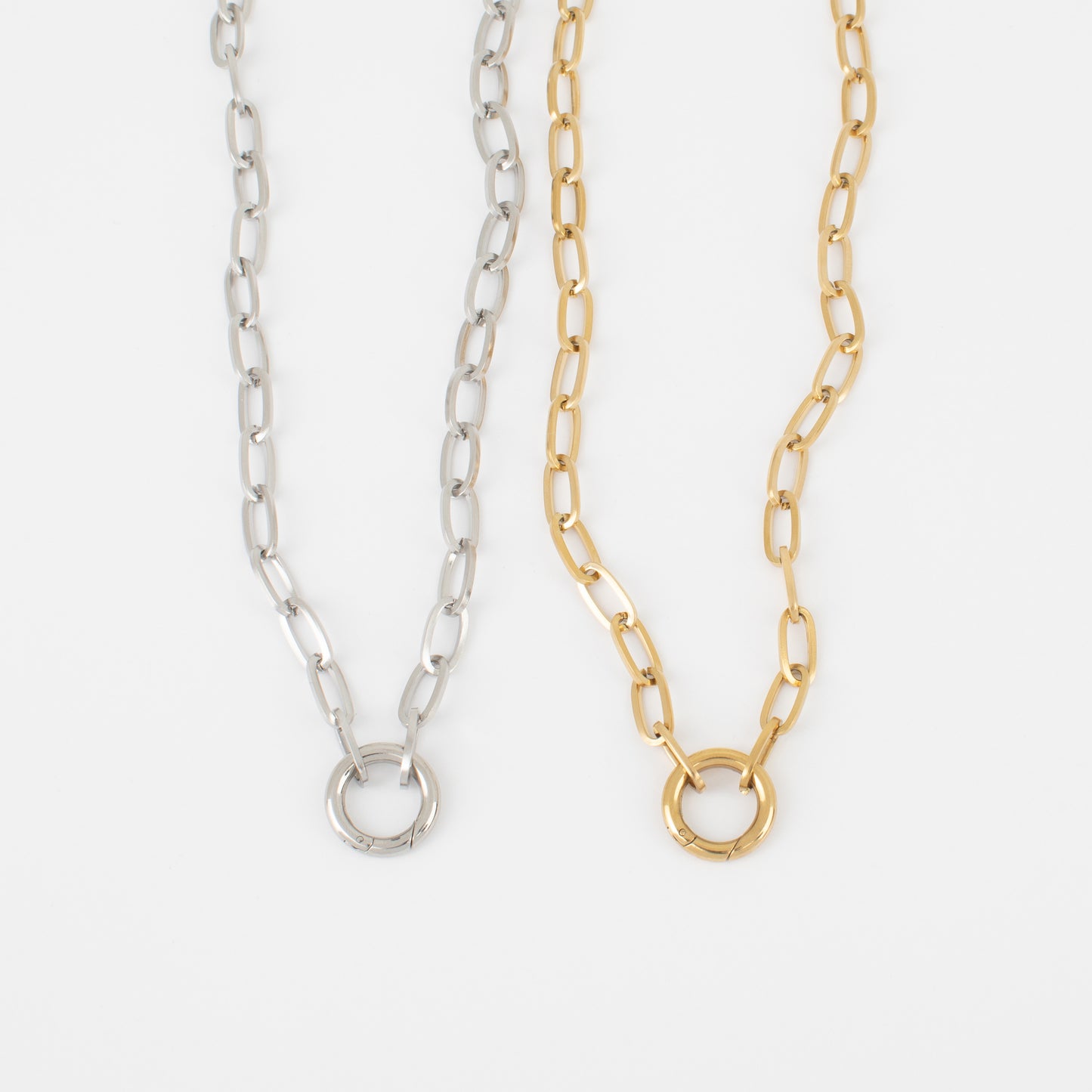 Two gold and silver chain necklaces on a white background