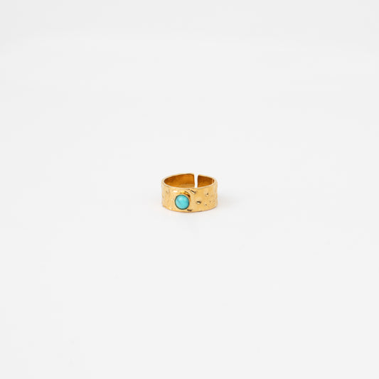 Gold ring with a turquoise stone on a white background