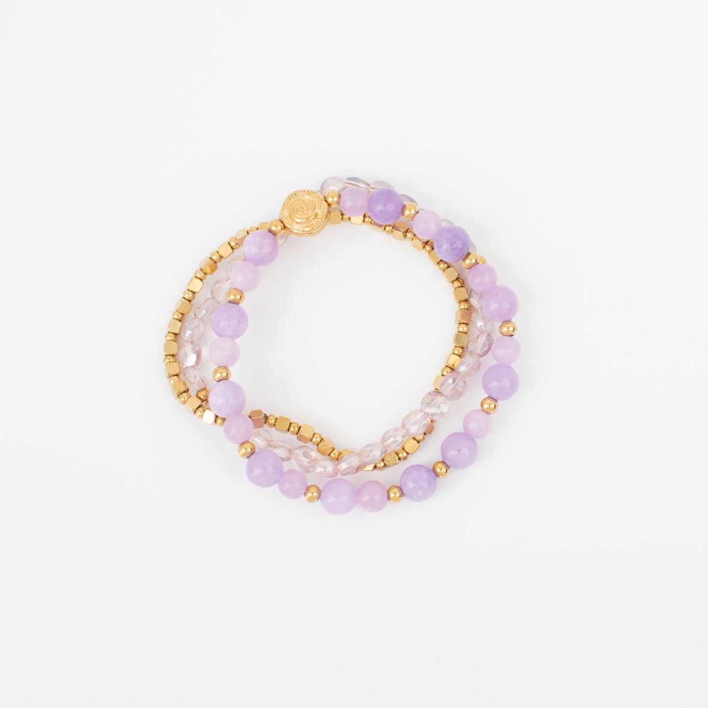 Set of three beaded bracelets with gold accents on a white background