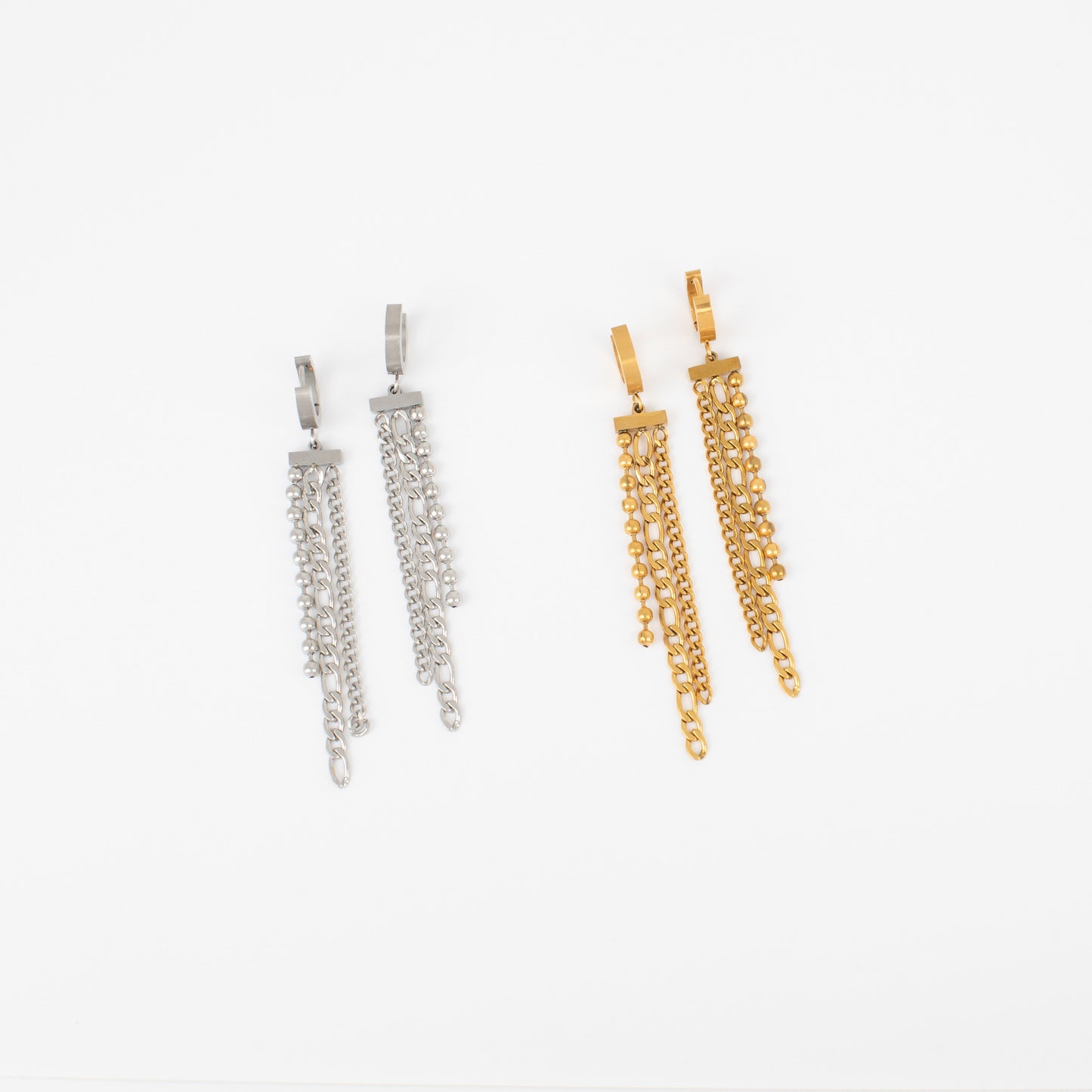 Pair of silver and gold chain earrings on a white background