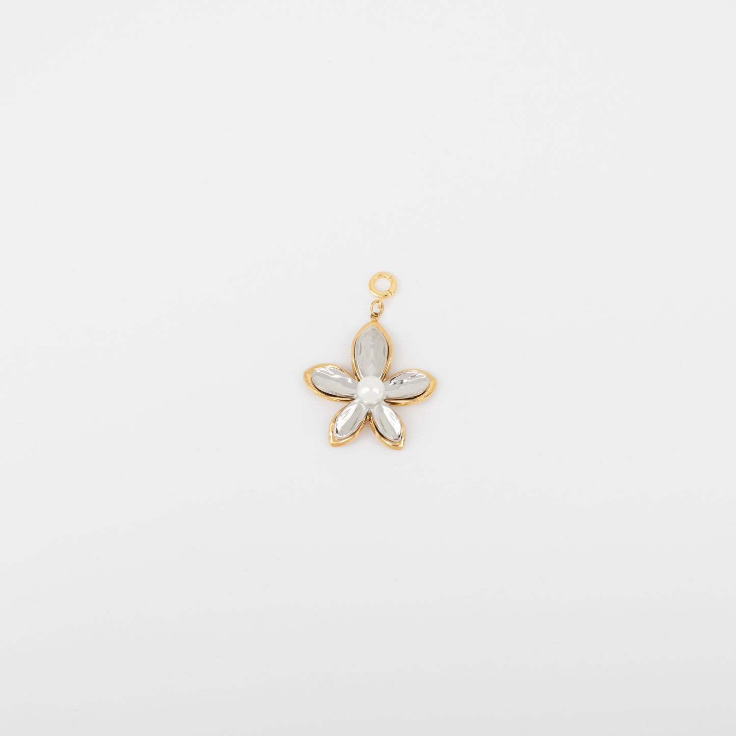 Gold flower-shaped pendant with a central pearl on a light gray background