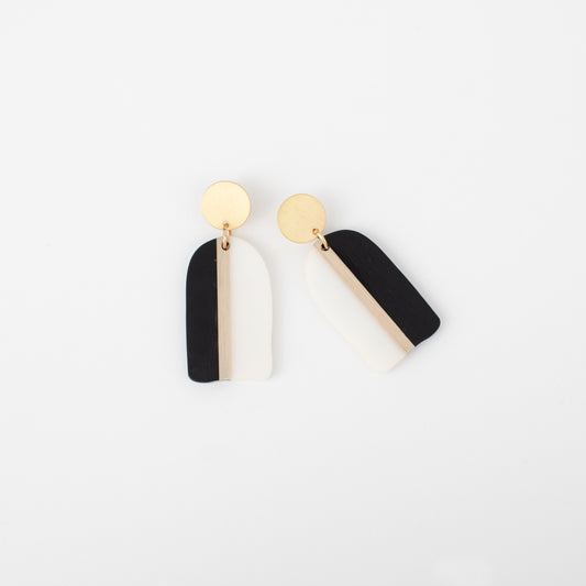Black and gold earrings on a white background