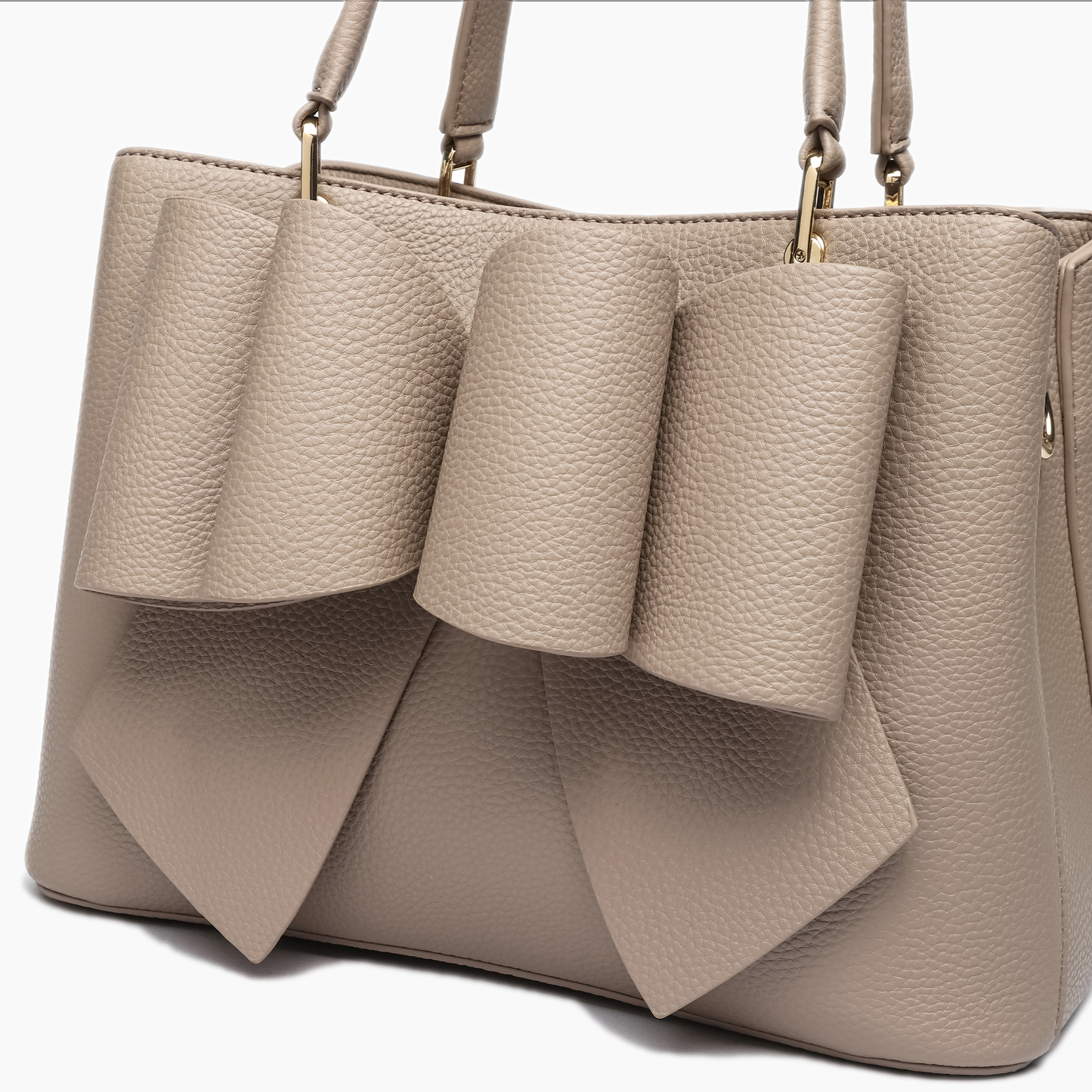 Beige handbag with bow design on a white background