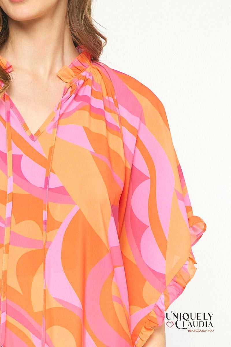 Woman wearing ruffle pink tunic