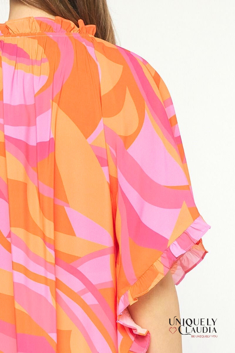 Woman wearing ruffle orange multi tunic