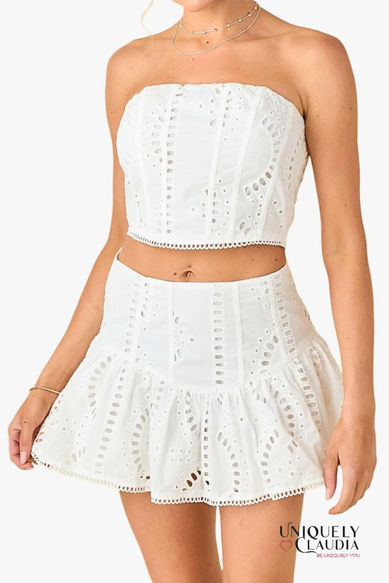 White strapless top and skirt set with eyelet details on a white background