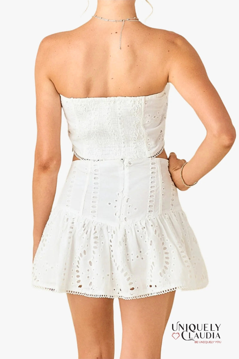 White strapless two-piece with intricate detailing on a white background