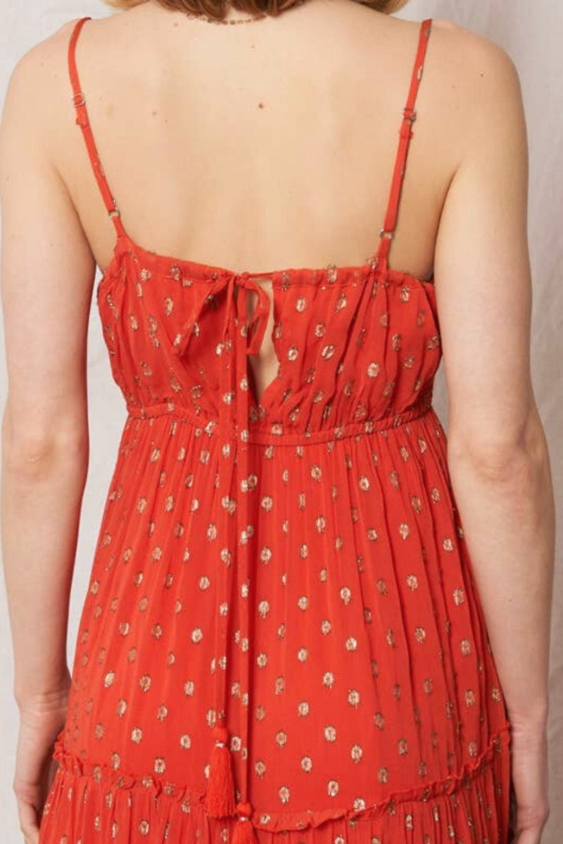 Red patterned dress with thin straps on a plain background