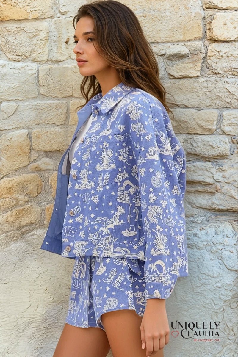 Woman wearing a blue patterned outfit standing against a stone wall, with 'Uniquely Claudia' branding.