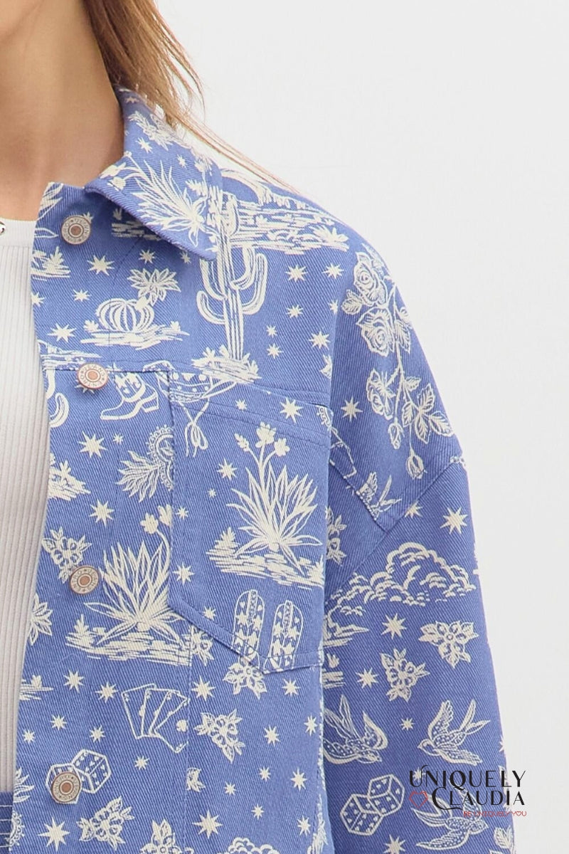 Blue denim jacket with white cactus and desert landscape pattern on a white background