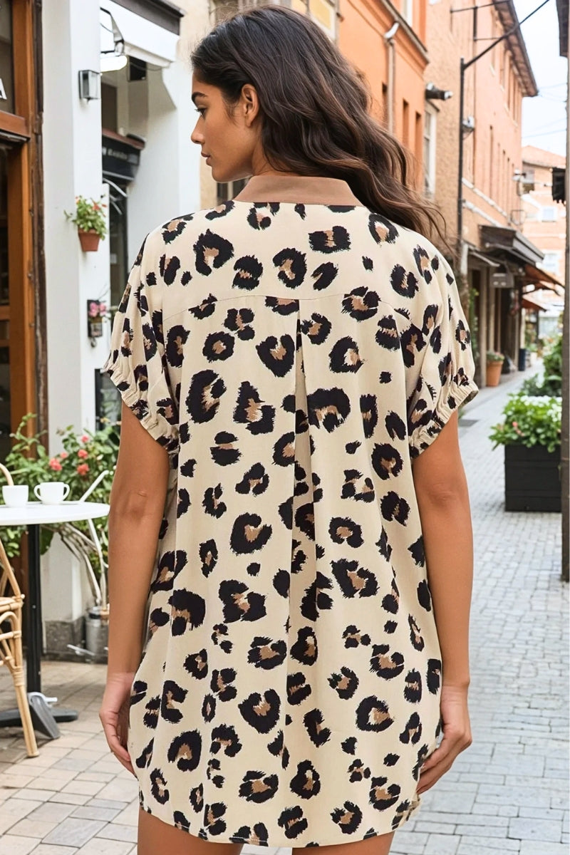 Woman wearing a leopard print dress on a street in an urban setting