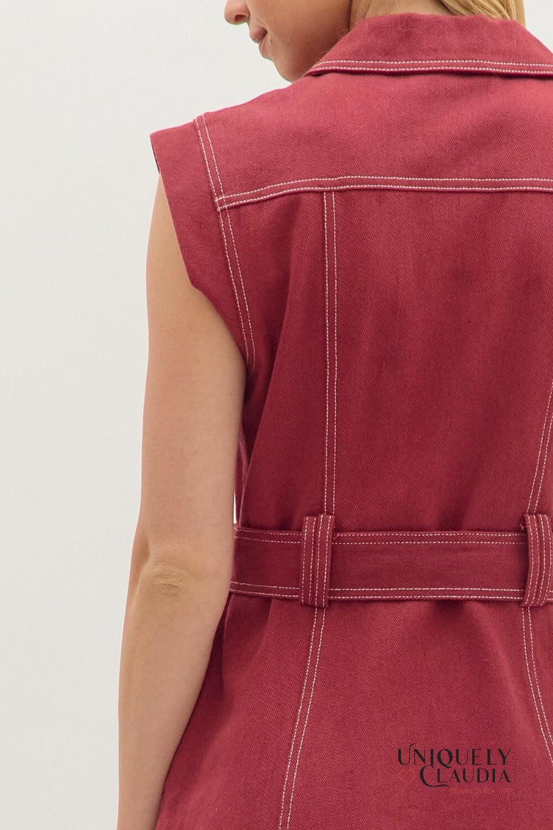 Red sleeveless jacket with a belt on a plain background