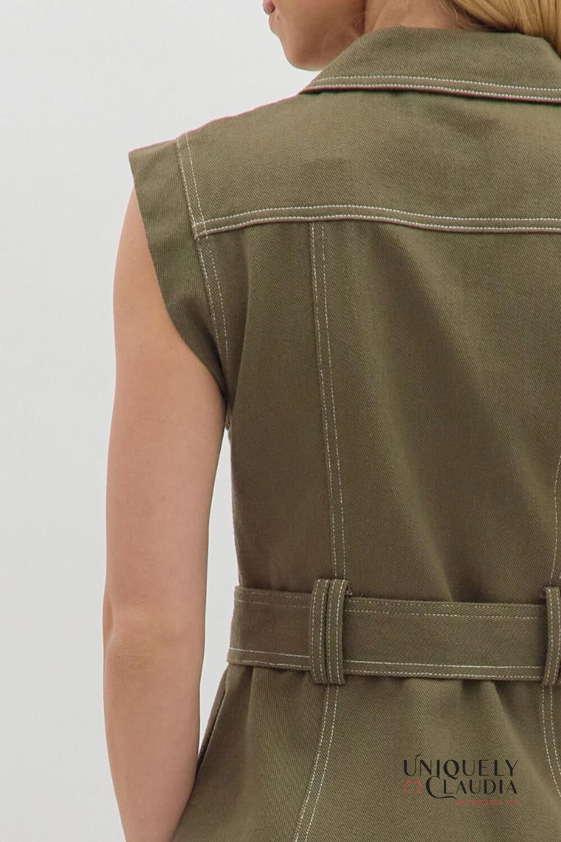 Green sleeveless dress with a belt on a plain background