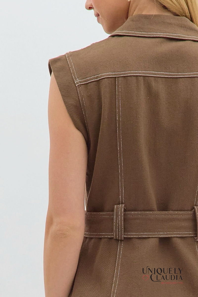 Brown vest with a belt and 'Uniquely Claudia' branding on a light gray background