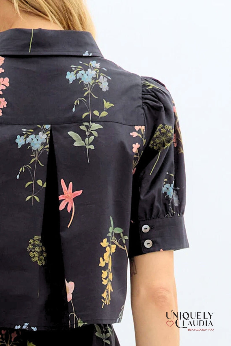 Floral-patterned shirt with colorful flowers on a plain background