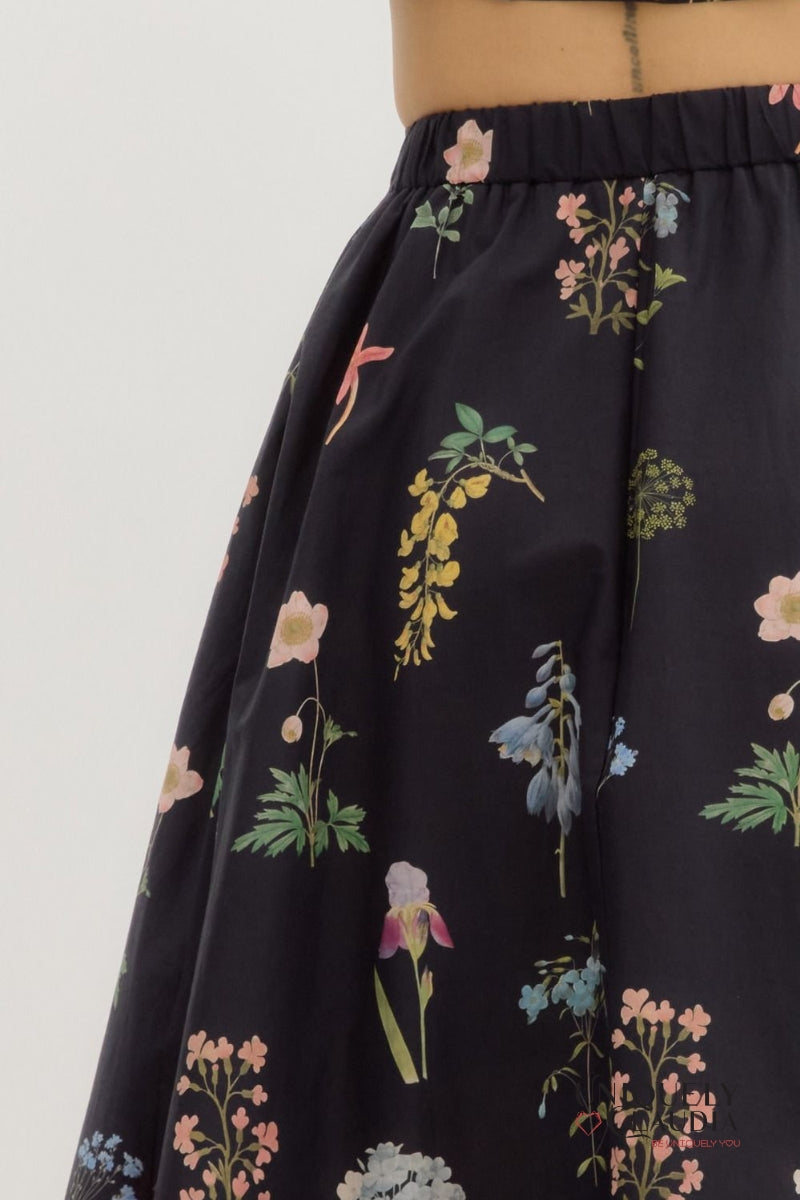 Black skirt with colorful floral pattern on a white background