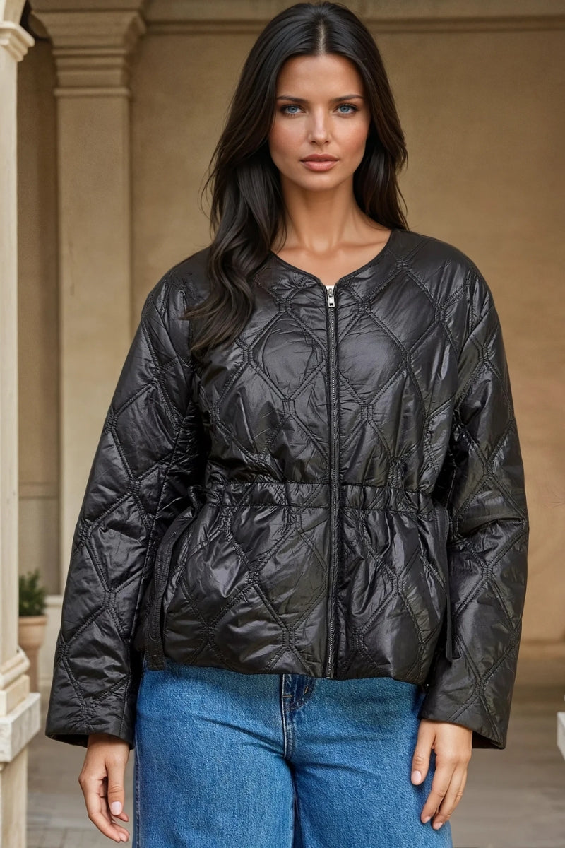 Woman wearing a black quilted jacket outdoors