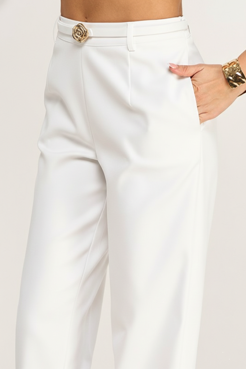 White pants with a gold button on a white background