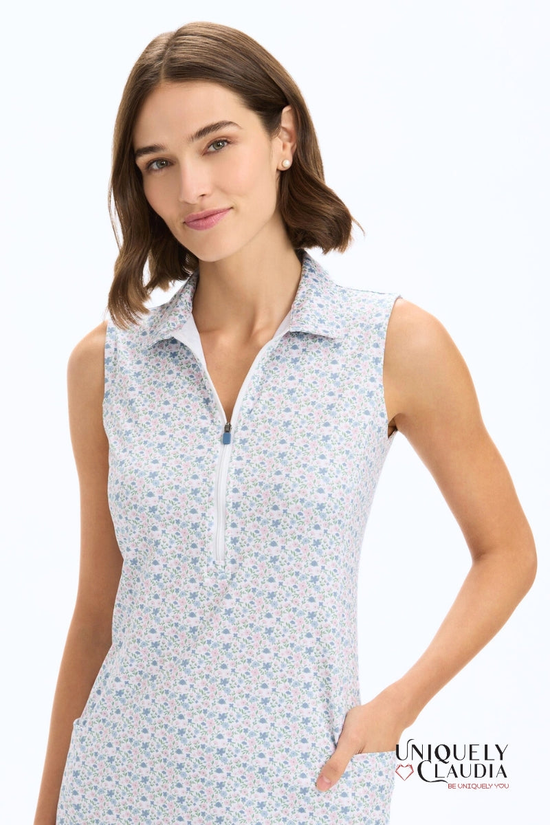 Woman wearing a sleeveless floral dress with a white background