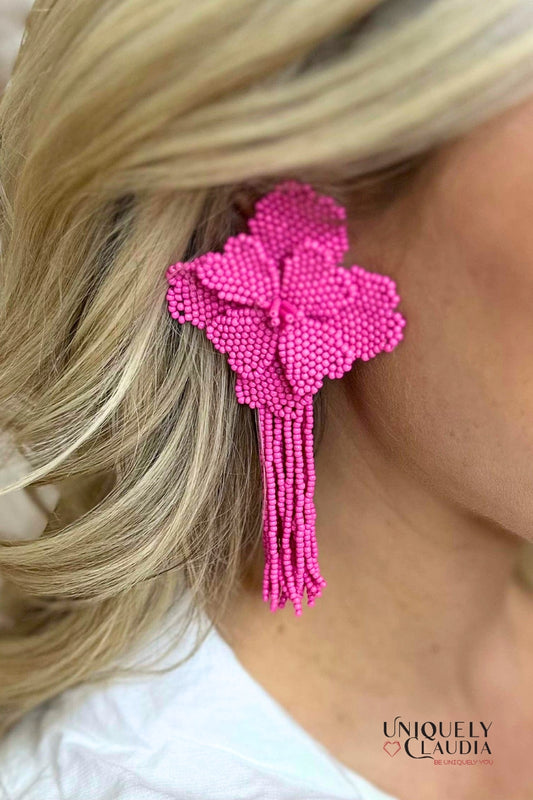 Close-up of a pink beaded hair clip worn by a person with blonde hair.