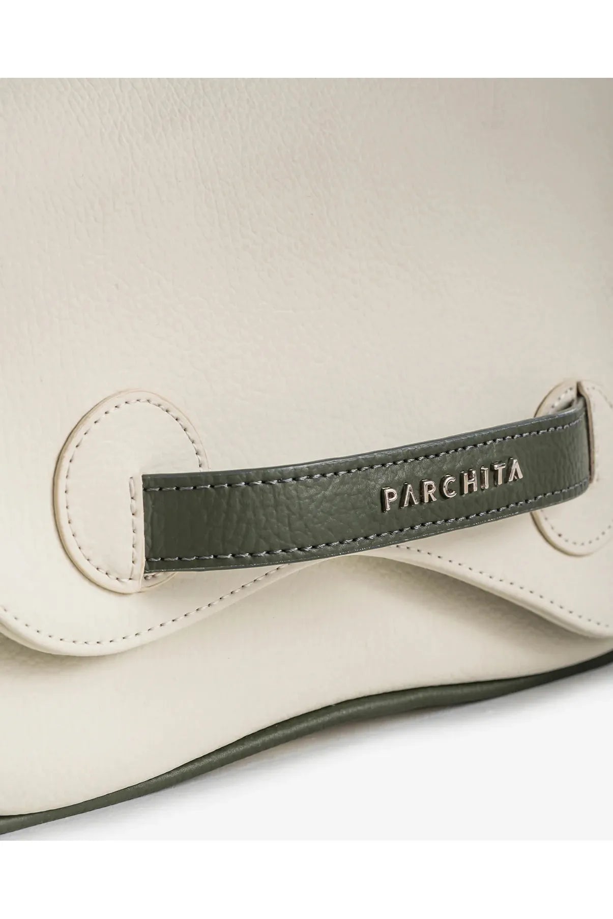 Close-up of a beige Parchita Brand handbag with a green leather tag