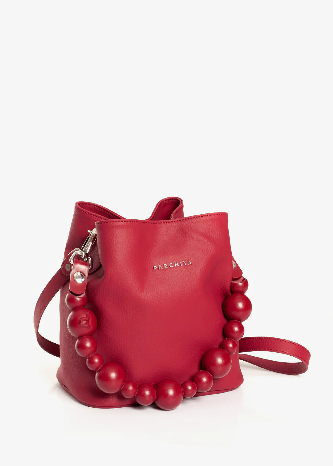 Red handbag with pearl embellishments on a white background