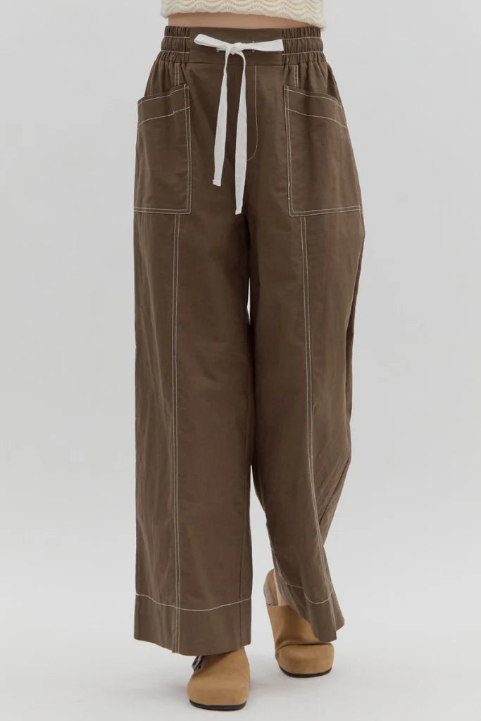 Brown pants with a white drawstring on a white background