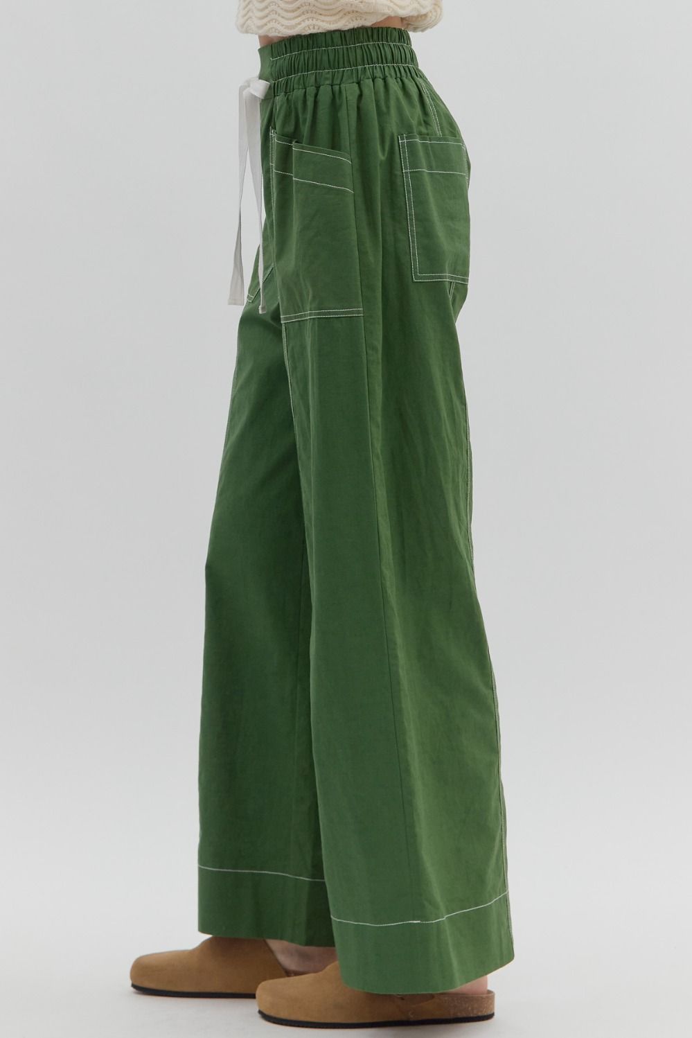 Green wide-leg pants on a plain background