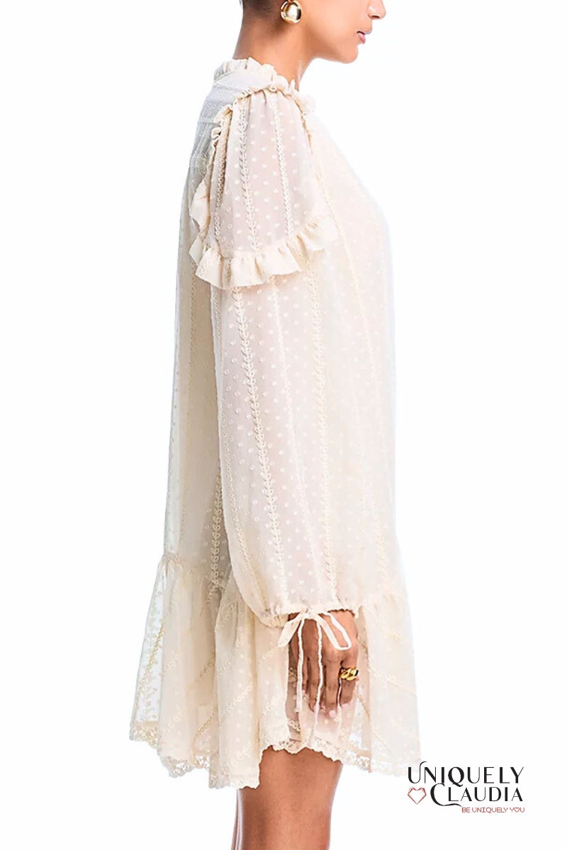 White lace dress with ruffled sleeves on a white background, featuring the brand 'Uniquely Claudia'.