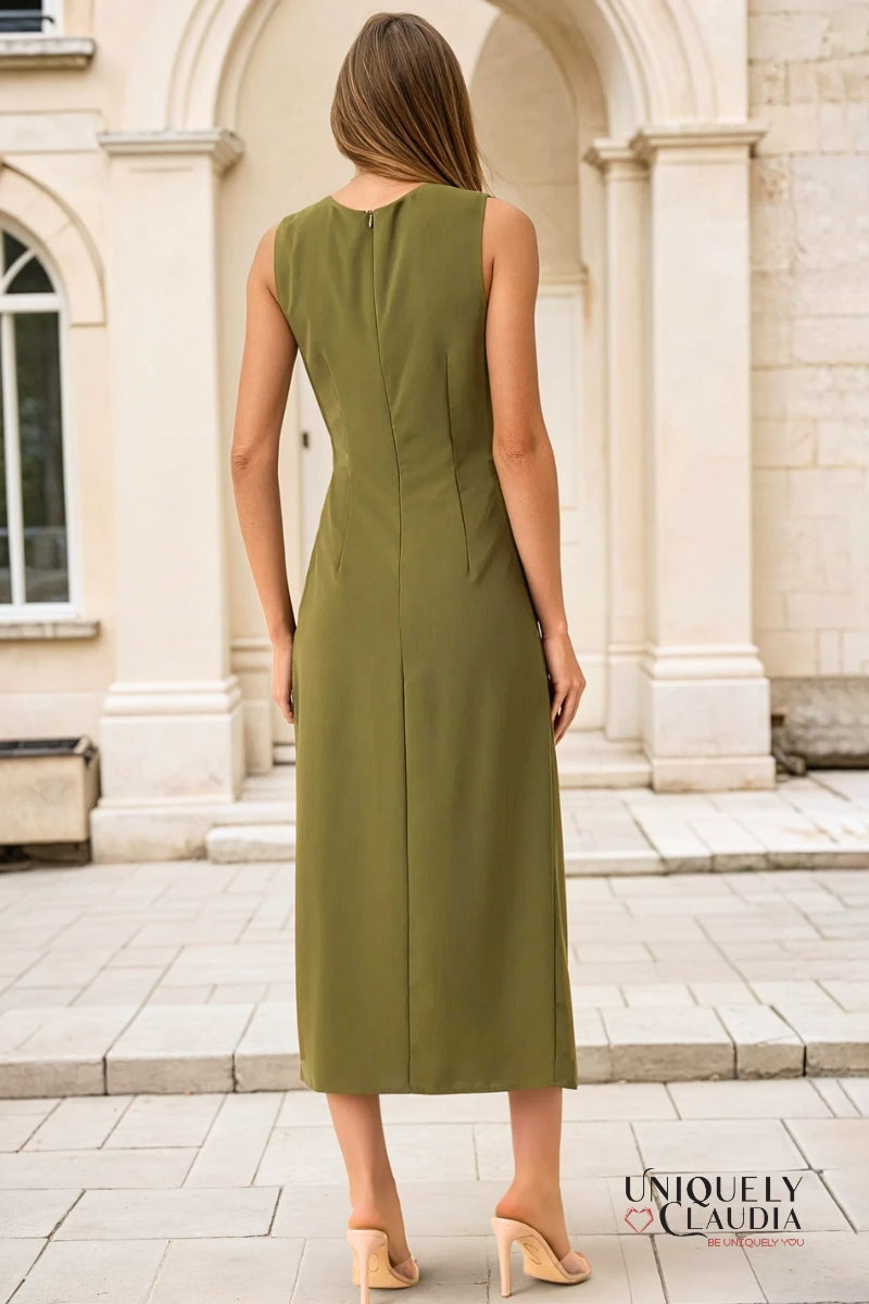 Woman wearing a green dress standing in front of classical architecture