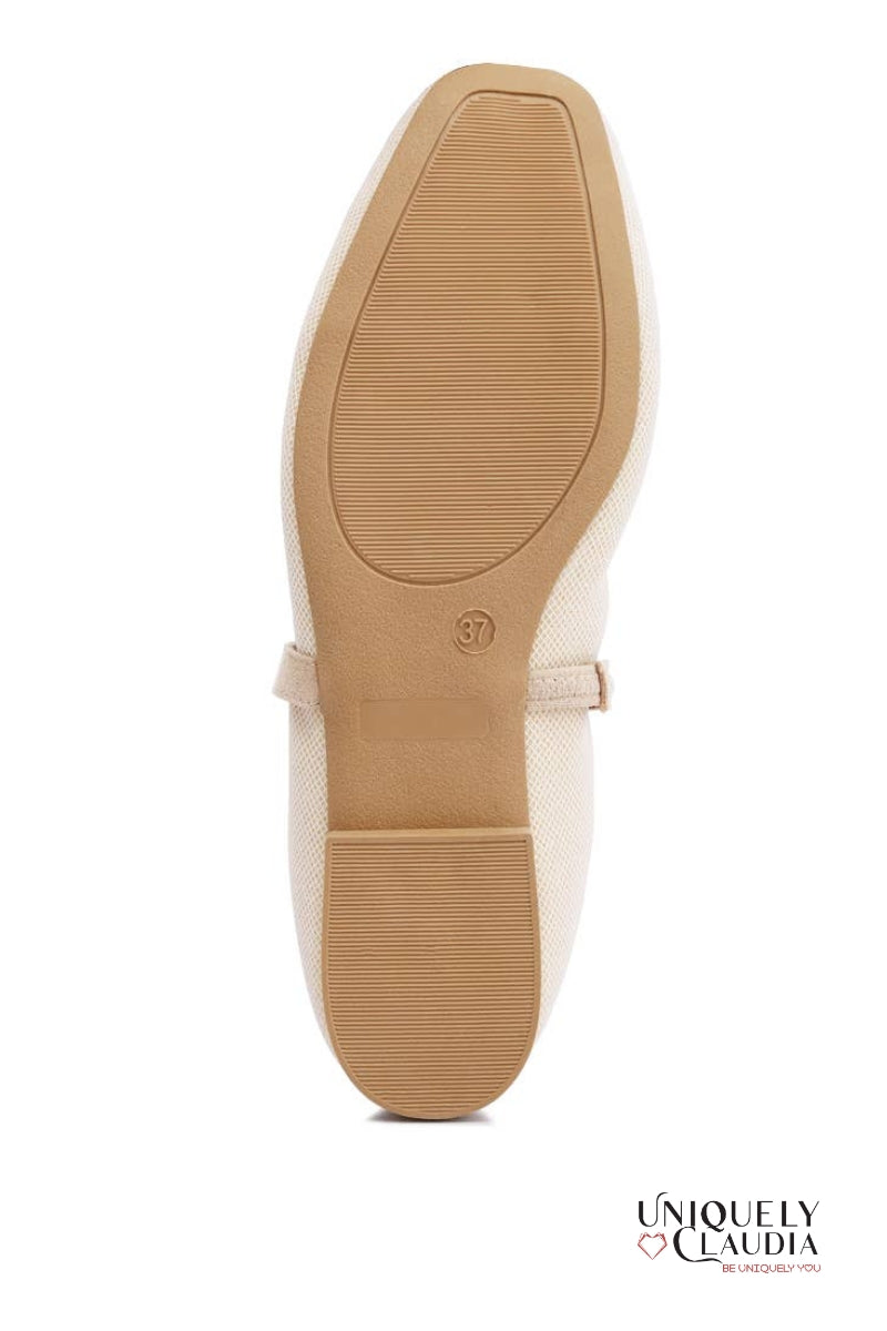 Close-up of a shoe sole with a visible brand logo on a white background