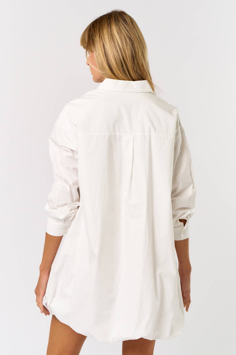 Woman wearing a white shirt on a plain background