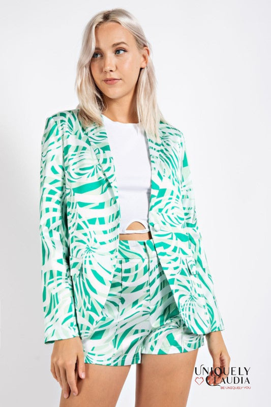 woman wearing green palm print satin blazer